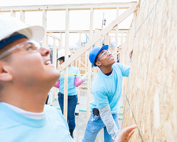 Photo of people building home for charity.